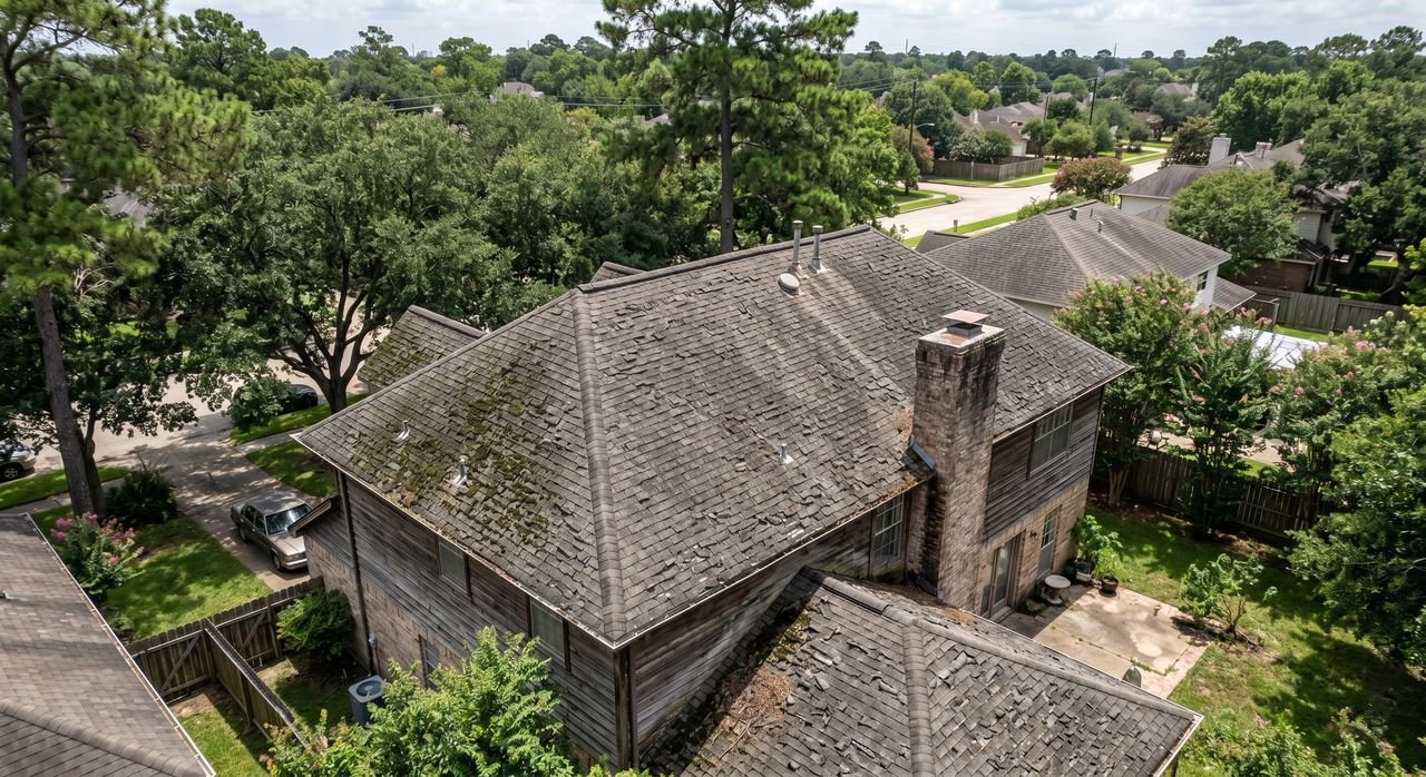 Before: worn aerial view of old shingle roof